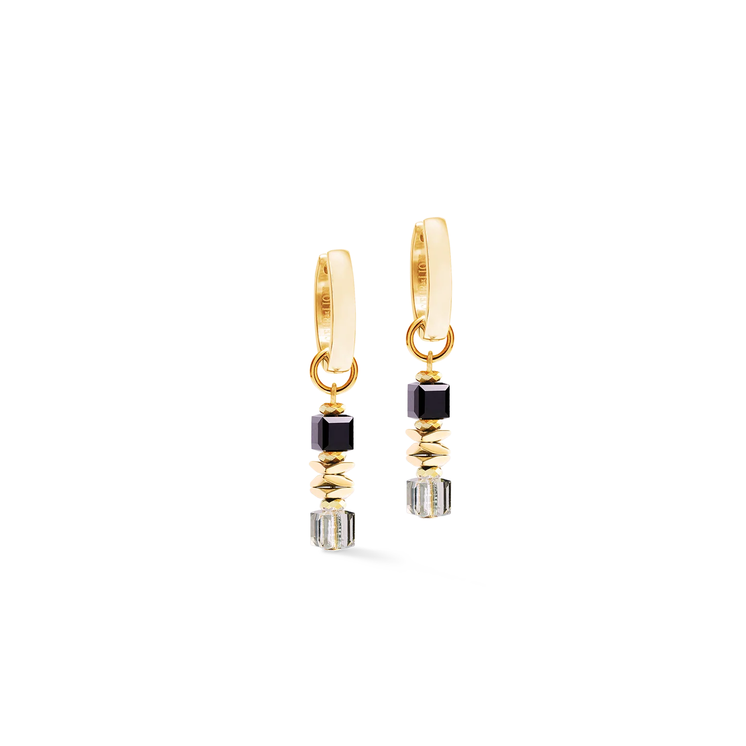 De Wave Cube Flow-oorringen in goud en zwart combineren gedurfde contrasten met verfijnde geometrie in een eigentijdse interpretatie van de Wave Cube Flow-collectie. Diepzwarte tinten, warme gouden accenten en schitterende kristaldetails zorgen voor een verfijnde uitstraling die zowel opvallend als elegant ingetogen is. De gebalanceerde verhoudingen weerspiegelen het vloeiende ritme dat kenmerkend is voor de collectie. De lichtgewicht hangers bewegen op natuurlijke wijze mee, vangen bij elke beweging het licht en zorgen de hele dag door voor een subtiele schittering. Gecombineerd met de bijpassende ketting en armband vormen de oorbellen een harmonieus geheel dat staat voor moderne luxe en tijdloze stijl. Goudkleurige hematiet, Swarovski&reg;-kristallen en hoogwaardig goudkleurig roestvrij staal vormen een verfijnde combinatie van elegante materialen en eigentijds design.