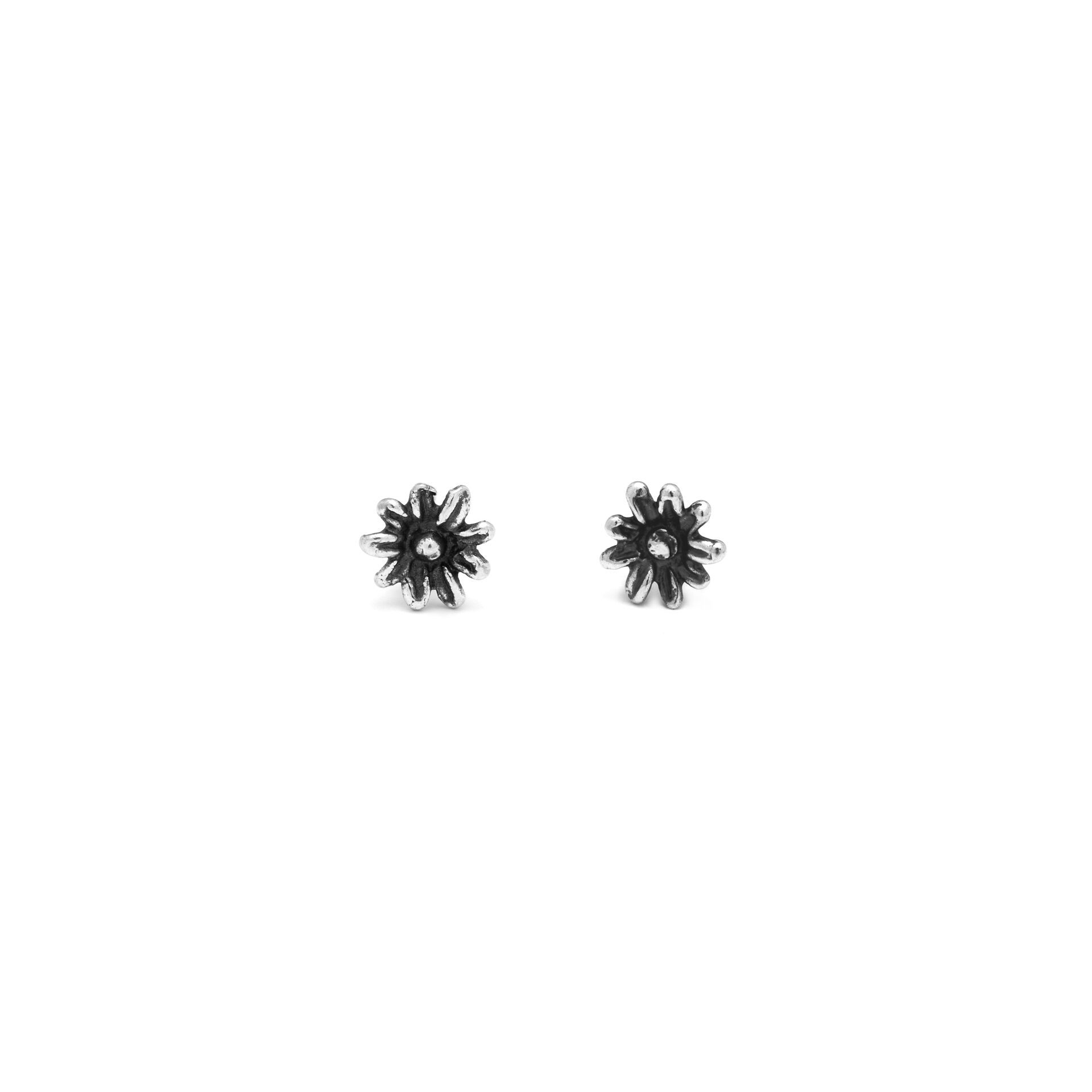 A microcosm of beauty in which burnished silver blossoms into delightful daisies. Perfect little handmade earrings that tell a wonderful story.